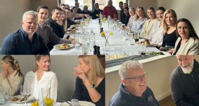 A collage of photos capturing an informal networking property lunch with the staff from a law firm based in Haywards Heath. The top image is a wide shot of everyone seated at a long, fully-set dining table in a bright, modern room. Two close-up images at the bottom show colleagues smiling, talking, and laughing, highlighting the friendly and positive atmosphere in West Sussex