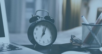 Alarm clock close up next to documents to show deadline for s21 is soon