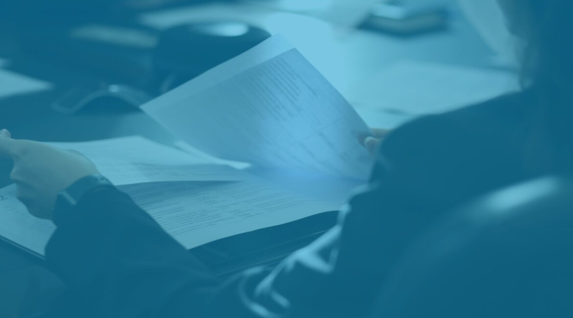 High Court earn-out dispute solicitor reviewing legal documents in meeting