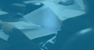 High Court earn-out dispute solicitor reviewing legal documents in meeting