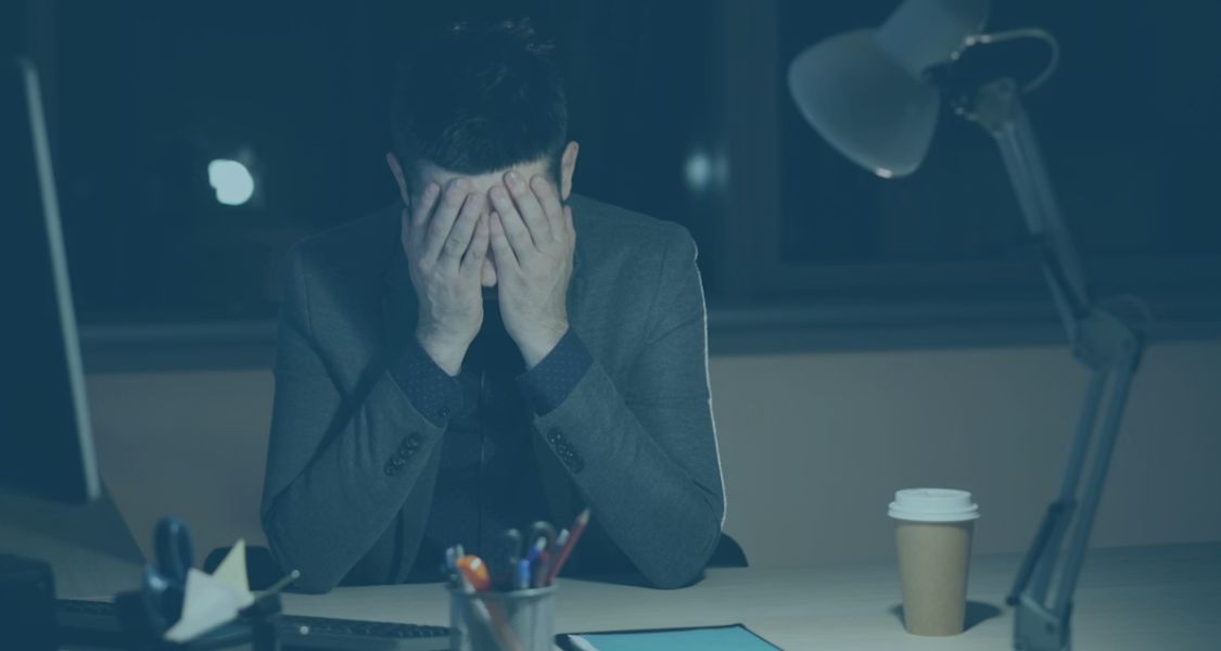 Stressed minority shareholder sat at their desk after being shut out of their company
