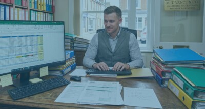 UK business owner reviewing tax planning and company ownership structure Business tax planning for owner-managed companies and shareholders Legal and tax planning for business sales, succession and profit extraction