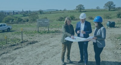 Landowner and developer reviewing plans for development land subject to an overage agreement