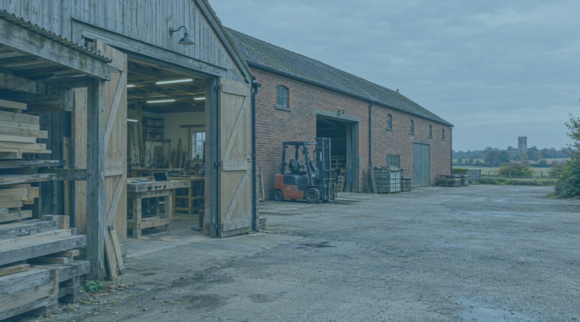 Joinery workshop and adjoining red-brick warehouse near Norwich, illustrating a business demerger.