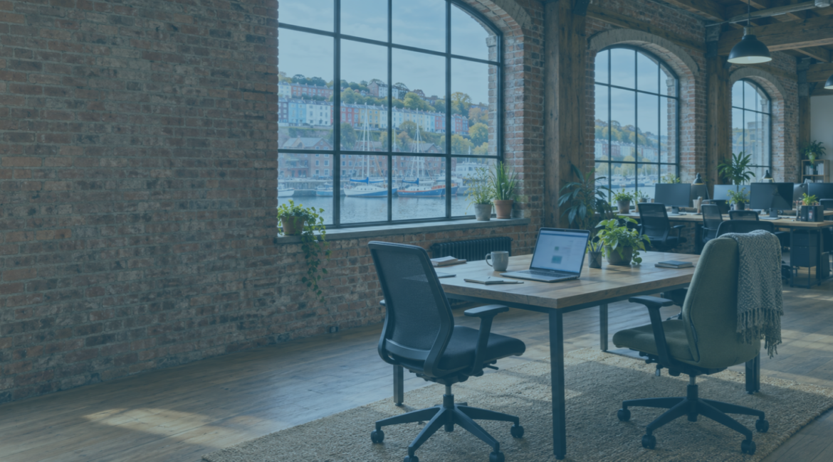 Open laptop in a converted warehouse office overlooking Bristol harbour, illustrating shadow AI in the workplace.