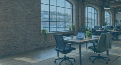 Open laptop in a converted warehouse office overlooking Bristol harbour, illustrating shadow AI in the workplace.