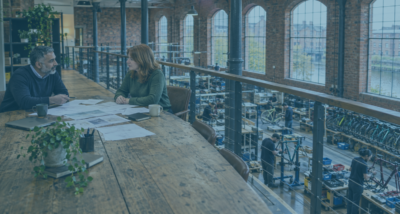 Two bicycle company co-owners discussing business separation in a converted Greater Manchester mill, as shareholders no longer want to work together.